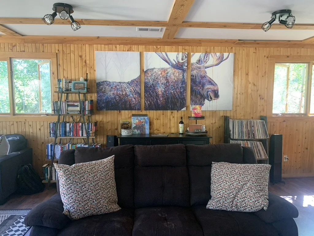 Lodge living area with sofas and a moose painting